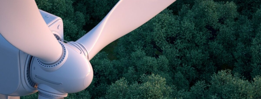 Wind Turbine fan in front of trees