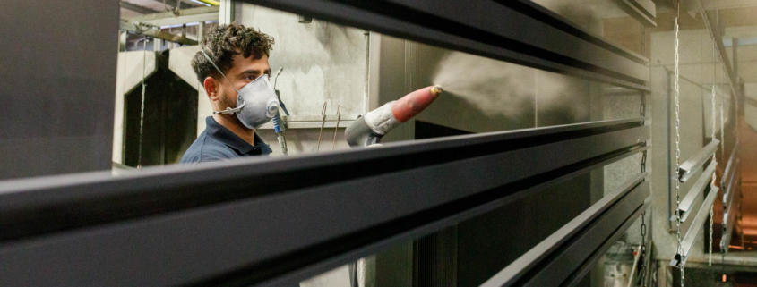 Man wearing facemask spraying aluminium